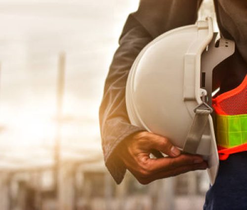 Technician holding white hat safety hard hat sunlight background