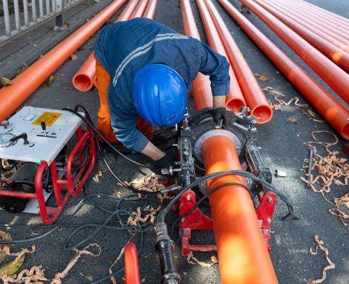 An engineering worker is repairing a pipeline An engineering worker is repairing a pipeline