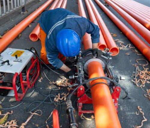 An engineering worker is repairing a pipeline